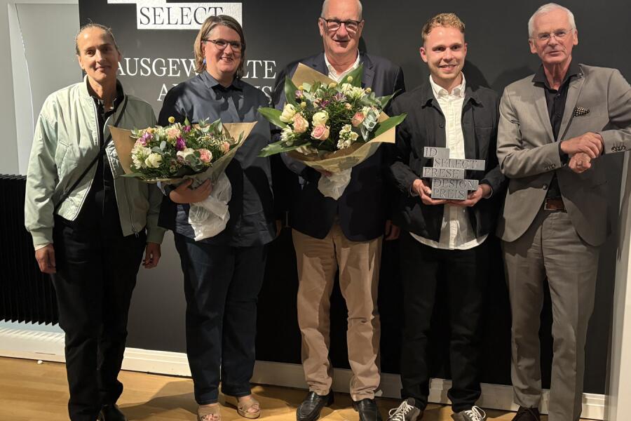 Fünf Menschen, 2 Frauen und 3 Männer, stehen nebeneinander und schauen zum Betrachter, zwei haben Blumensträuße in der Hand